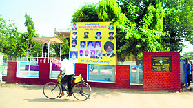Hoardings of political parties cover the area in front of Karnail Singh Benipal's statue at Issru.