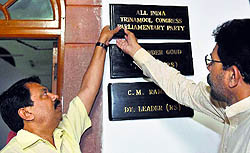 TDP MPs remove a name plate of a TMC MP from Room No. 5 at Parliament House in New Delhi on Tuesday
