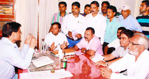 Activists of the BJP meet an official in Dehradun on Tuesday.