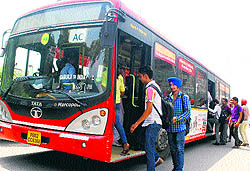 Passengers board a city bus in Amritsar on Wednsday