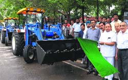 Chandigarh Mayor Harphool Chandra Kalyan flags off four front-end loaders at the office of the Municipal Corporation in Sector 17, Chandigarh, on Wednesday. The vehicles, purchased at the cost of ~45.25 lakh, are meant to strengthen the sanitation wing of the civic body. Tribune photo: S Chandan