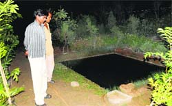 The victims father shows the water tank in which his son drowned at Prajaypati Nursery at Mani Majra on Wednesday. Tribune photo: Vicky Gharu