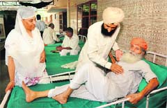 Shamsher Singh and his wife, Rajinder Kaur, take care of an abandoned elderly person at Prabh Asra in Kurali. Tribune photo: Vicky Gharu