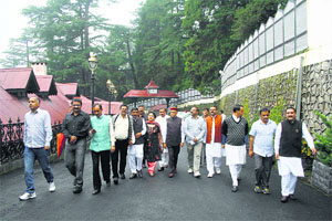 Former Chief Minister Prem Kumar Dhumal with other BJP MLAs on their way to the Raj Bhawan in Shimla on Wednesday.