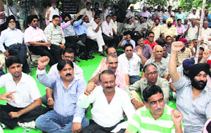 State BJP vice-president Ravi Mahendru protests with traders at the Excise and Taxation Department office in Jalandhar on Wednesday.