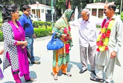 Celebrating the sprit of friendship, Tandons from Jammu receive Mughals from PoK (with garlands) in Srinagar on Wednesday. PTI 