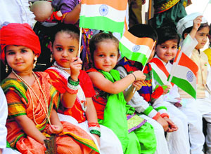 Tiny-Tots of Daddys Teddy playway school hold the national flag to celebrate the Independence Day in Bathinda on Thursday.