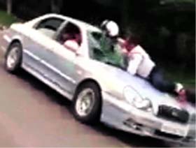 Video snapshots of a UT police constable Devinder Singh atop the bonnet of a car near the Sectors 9/10/16/17 roundabout on Sunday. The constable kept hitting the windowpane with his helmet even as the driver refused to apply brakes.
