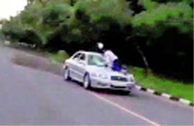 Video snapshots of a UT police constable Devinder Singh atop the bonnet of a car near the Sectors 9/10/16/17 roundabout on Sunday. The constable kept hitting the windowpane with his helmet even as the driver refused to apply brakes.