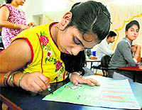 A child with special needs takes part in a painting competition on the theme of patriotism in Ludhiana