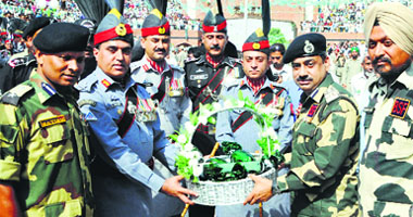 BSF DIG MF Farooqui receives sweets from Pakistan Rangers DIG Khan Tahir Javed Khan at the Attari checkpost