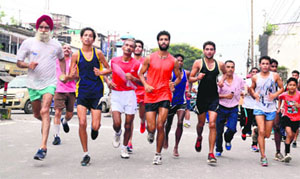 Athletes take part in a cross-country race in Dehradun on Thursday. 