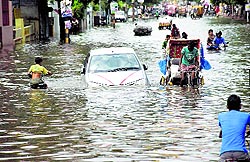 Vehicles move through a waterlogged road in Patna on Saturday