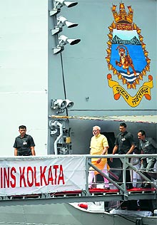 Prime Minister Narendra Modi walks down the gangplank of INS Kolkata, countrys biggest indigenously built warship, which was commissioned in Mumbai on Saturday