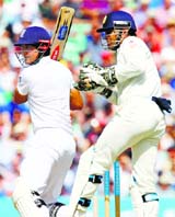 Englands captain Alastair Cook hits a shot to reach his 50 on the second day of the fifth Test at the Oval in London on Saturday.