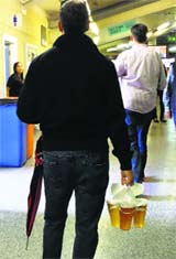 A spectator carries glasses of beer during the Test on Saturday.