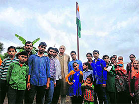 Residents of Dolsi village in Tehri district hoist the National Flag on Friday.