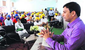 Deputy Commissioner Ravi Bhagat addresses volunteers of Akal Purkh Ki Fauj at Bhai Gurdas Hall in Amritsar on Sunday