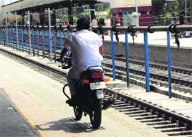 A man on his motorcycle at a platform of the city railway station