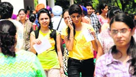 Students come out of an examination centre after appearing for the BDS entrance exam on Sunday.