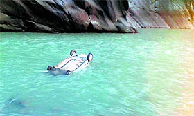 A car floats in the Ravi at Gehra in Bharmour on Sunday.