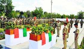 The BSF Director General pays floral tributes on Sunday to the slain personnel of the force who were killed in a militant attack in Pulwama on Saturday.