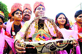 Devotees carry a Krishna “palki” at a temple