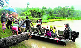 Army troops rescue people from flood-affected Kalapani village in Nagaon district of Assam on Sunday