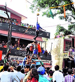 Youths try to break a matki on the occassion of Janmashtami celebrations at Sai Temple in Dehradun on Sunday