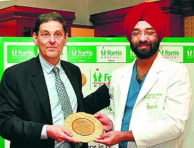 The father of orthopilot, Prof Frederic Picard, felicitates Dr Harsimran Singh (right) at Fortis Hospital in Mohali on Monday.