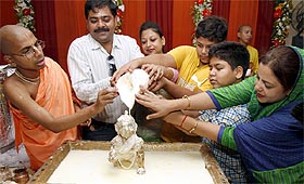 Devotees perform puja on the occasion of Janmashtami at Iskcon Temple in New Delhi on Monday.