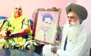 Charanjit Kaur and Amrik Singh with picture of their son Avtar Singh, who was allegedly killed by Gurmeet Singh Pinki