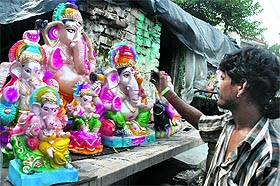 An artist gives finishing touches to an idol of Lord Ganesha ahead of 'Ganesh Chaturthi' in Jammu on Monday.