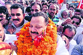 Devender Singh Rana, National Conference candidate from Nagrota, greets supporters after coming out of the airport in Jammu on Monday.
