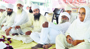 Members of the Namdhari sect sit on a hunger strike in Ludhiana on Monday.