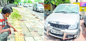 A man shows the spot where a Mahindra Quanto (right) ran over 13 homeless people  in Delhi on Monday.