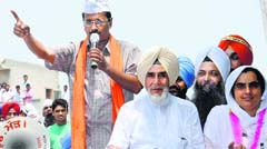 Aam Aadmi Party convener Arvind Kejriwal canvasses for party candidate Baljinder Kaur (extreme right) at Jeevan Singhwala village in Talwandi Sabo on Monday. Tribune photo: Pawan Sharma