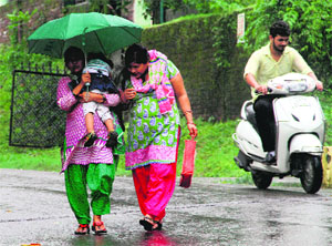 Out in the rain in Dehradun on Monday