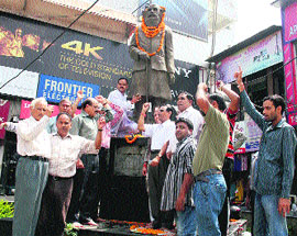 UKD workers garland the statue of Indramani Badooni, know as Gandhi of Uttarakhand, on his 15th death anniversary in Dehradun on Monday