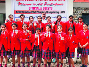 Girl shooters of Unison World school with their medals in Dehradun on Monday