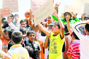 Refugees from the minority Yazidi sect, who fled the Iraqi town of Sinjar, take part in a protest at Nowruz refugee camp in Qamishli, northeastern Syria, on Monday.
