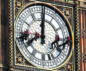 Abseilers polish the dial of the Big Ben Clock in London on Monday.