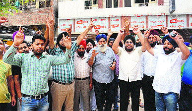 Hoteliers protest against the governments decision to close down their business in Amritsar on Tuesday.