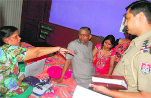 The victims, Rajabala (left) and her daughter-in-law Shikha, narrate the robbery incident to a police official at Phase VI, Mohali, on Tuesday.