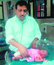 A doctor examines the baby girl at the General Hospital in Sector 6, Panchkula.