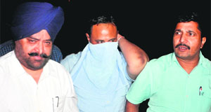 Surinder Garg, manager of Cooperative Bank at Sherpur village in Sangrur, in police custody in Mohali on Tuesday. 