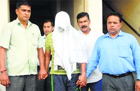 Vigilance Bureau officials with the arrested SHO in Gurgaon on Tuesday