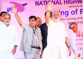 Prime Minister Narendra Modi and Union Minister Nitin Gadkari greet the crowd in Kaithal on Tuesday, as another Union Minister Krishan Pal Gurjar looks on