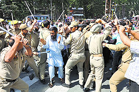 Police stop Public Health Engineering Department employees during a protest in Srinagar on Tuesday. 