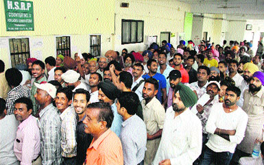 Applicants make a beeline at the counters for the payment of fee for high security registration plates at the office of DTO in Jalandhar on Tuesday.